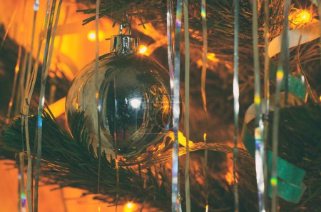 Photo for Christmas tree ball with garland lights closeup - Royalty Free Image