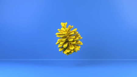 Photo for Single thin bright yellow pinecone floating in air on light blue background - Royalty Free Image