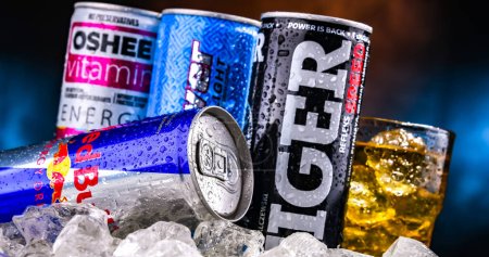 Photo for POZNAN, POL - NOV 25, 2022: Cans of popular global energy drinks, beverages containing stimulant drugs and marketed as providing mental and physical stimulation - Royalty Free Image