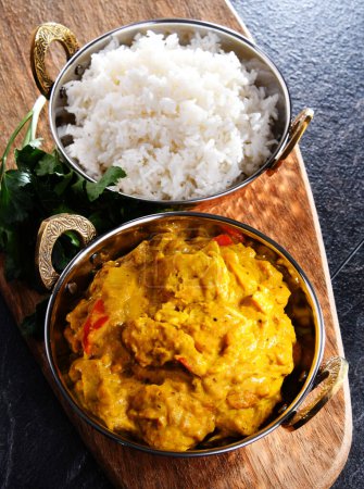 Photo for Curry chicken with rice served in original indian karahi pots. - Royalty Free Image