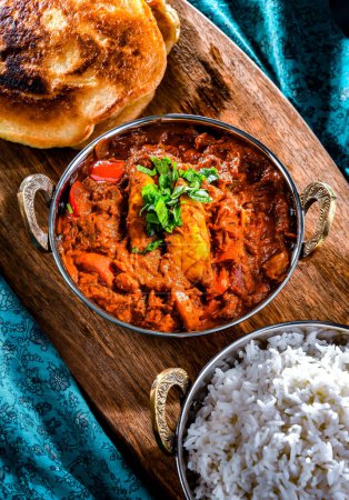 Photo for Butter chicken with rice and naan flatbread served in original indian karahi pots. - Royalty Free Image