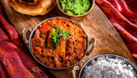 Photo for Butter chicken with rice and naan flatbread served in original indian karahi pots. - Royalty Free Image