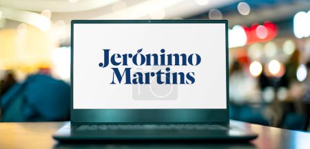 Photo for POZNAN, POL - NOV 22, 2022: Laptop computer displaying logo of Jeronimo Martins, a Portuguese corporate group that operates in food distribution and specialised retail - Royalty Free Image