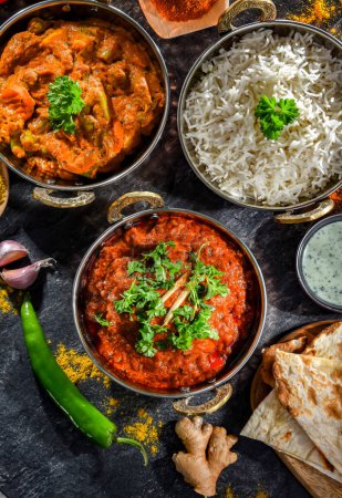 Heiße Madras Paneer und Gemüse-Masala mit Basmatireis, serviert in original indischen Karahi-Töpfen.