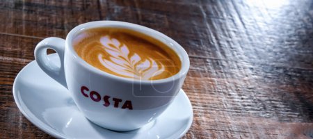 Photo for POZNAN, POL - APR 19, 2023: Cup of Costa Coffee, a brand of British multinational coffeehouse company headquartered in Dunstable, Bedfordshire; second largest coffeehouse chain in the world - Royalty Free Image