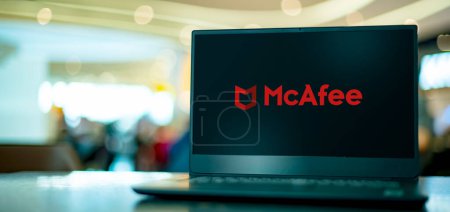 Photo for POZNAN, POL - APR 7, 2022: Laptop computer displaying logo of McAfee, a global computer security software company headquartered in Santa Clara, California, USA - Royalty Free Image