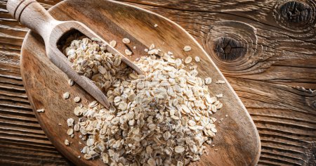 Photo for Rolled oats on the wooden cutting board. - Royalty Free Image