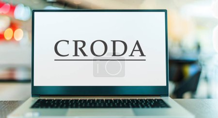 Téléchargez les photos : POZNAN, POL - DEC 28, 2022: Laptop computer displaying logo of Croda International, a speciality chemicals company based at Snaith, England - en image libre de droit