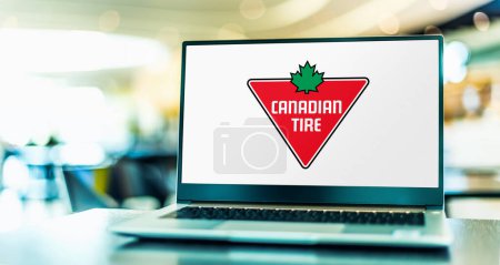 Photo for POZNAN, POL - NOV 22, 2022: Laptop computer displaying logo of Canadian Tire, a Canadian retail company which operates in the automotive, hardware, sports, leisure and housewares sectors - Royalty Free Image