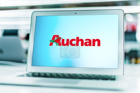 Photo for POZNAN, POL - MAY 1, 2021: Laptop computer displaying logo of Auchan, a French multinational retail group headquartered in Croix, France - Royalty Free Image