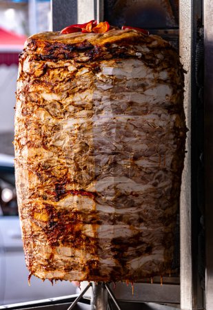 Photo for Traditional doner kebab roasted on vertical rotisserie in Turkish street restaurant - Royalty Free Image