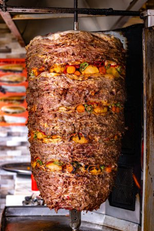 Photo for Traditional doner kebab roasted on vertical rotisserie in Turkish street restaurant - Royalty Free Image