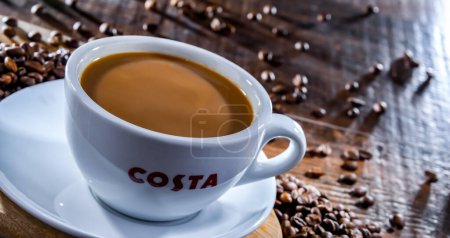Photo for POZNAN, POL - APR 19, 2023: Cup of Costa Coffee, a brand of British multinational coffeehouse company headquartered in Dunstable, Bedfordshire; second largest coffeehouse chain in the world - Royalty Free Image