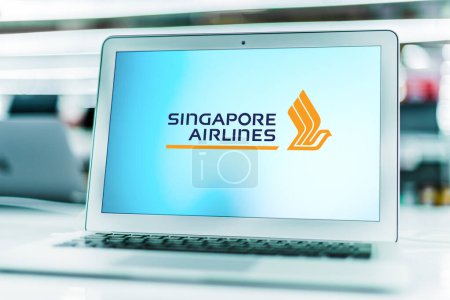 Photo for POZNAN, POL - MAR 15, 2021: Laptop computer displaying logo of Singapore Airlines, the flag carrier airline of Singapore with its hub at Singapore Changi Airport - Royalty Free Image