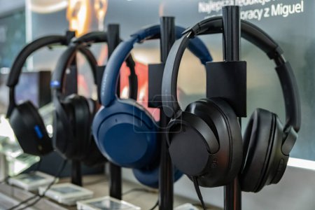 Photo for POZNAN, POL - DEC 8, 2023:  Sony headphones on stands put up for sale in a store. - Royalty Free Image
