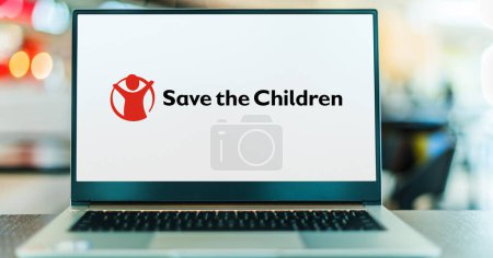 Photo for POZNAN, POL - DEC 5, 2023: Laptop computer displaying logo of Save the Children, an international, non-government operated organization - Royalty Free Image