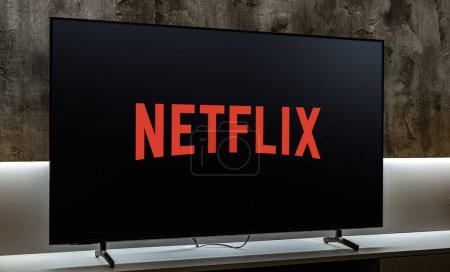 Photo for POZNAN, POL - DEC 19, 2023: Flat-screen TV set displaying logo of Netflix, an American media-services provider headquartered in Los Gatos, California, USA - Royalty Free Image