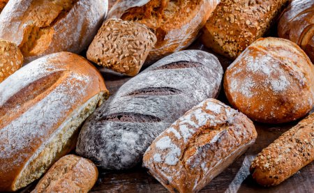 Photo for Assorted bakery products including loaves of bread and rolls - Royalty Free Image
