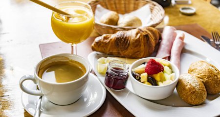 Photo for Breakfast served with coffee, orange juice and croissants. - Royalty Free Image