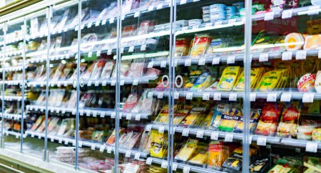 Foto de LEUVEN, BÉLGICA - 26 AGO 2022: Productos alimenticios exhibidos en un refrigerador comercial en el supermercado - Imagen libre de derechos