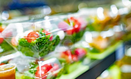 Photo for Pre-packaged vegetable salads displayed in a commercial refrigerator - Royalty Free Image