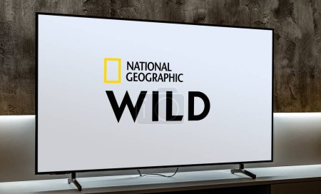 Photo for POZNAN, POL - MAR 01, 2024: Flat-screen TV set displaying logo of National Geographic Wild, a global pay television network owned by National Geographic Partners - Royalty Free Image