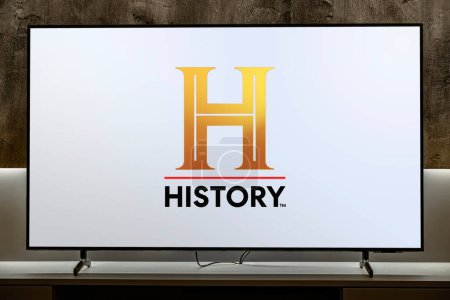 Photo for POZNAN, POL - MAR 01, 2024: Flat-screen TV set displaying logo of History, a pay television network that is owned by A+E Networks - Royalty Free Image