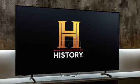 Photo for POZNAN, POL - MAR 01, 2024: Flat-screen TV set displaying logo of History, a pay television network that is owned by A+E Networks - Royalty Free Image