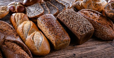 Photo for Assorted bakery products including loaves of bread and rolls. - Royalty Free Image