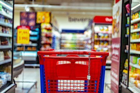 Photo for A shopping cart by a store shelf in a supermarket - Royalty Free Image