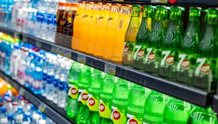 Photo for MUSCAT, OMAN - MAR 14, 2024: Bottles of cold drinks put out for sale in a commercial refrigerator - Royalty Free Image