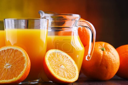 Photo for Glasses with freshly squeezed orange juice and fruits - Royalty Free Image
