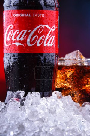 Photo for POZNAN, POL - AUG 13, 2019: A bottle and a glass of Coca-Cola, a carbonated soft drink manufactured by The Coca-Cola Company headquartered in Atlanta, Georgia, USA - Royalty Free Image