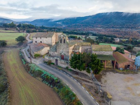Photo for Santa Fe de Valldeperes Romanesque church from the 12th century linked to Castelladral, with a single nave and apse. With two side chapels as a transept to place altarpieces. It is worth noting the belfry. Catalonia Spain - Royalty Free Image