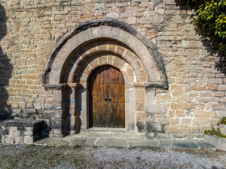 Photo for Church of San Ramon de Soberana de Ferrans, Romanesque from the 12th century, with a plan with two naves, and apses with a quarter sphere vault. The access door in the south wall, formed by three semicircular arches, access door detail - Royalty Free Image