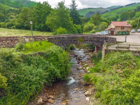 Photo for Bridge over the Nansa of Carmona river, Cabuerniga valley, Cantabria in Spain. named beautiful town of Spain - Royalty Free Image
