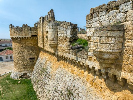 Photo for Castle of Grajal de Campos in Leon. detail of the defense walls and an old cannon that appears - Royalty Free Image