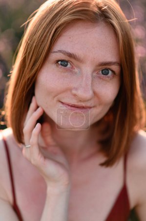 Photo for A red-haired young girl without makeup looks into the frame. Close-up portrait - Royalty Free Image