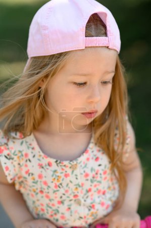 Photo for Little girl 3 years old in a pink cap. Close-up. Summer time. - Royalty Free Image