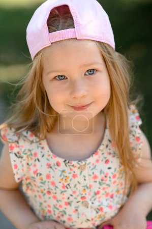 Photo for Little girl 3 years old in a pink cap. Close-up. Summer time. - Royalty Free Image