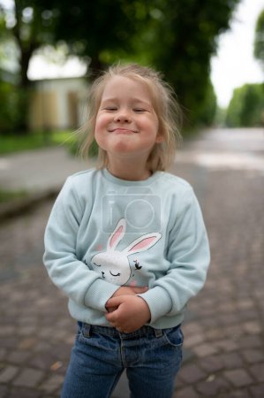 Photo for A little girl smiles funny at the camera. Close-up. - Royalty Free Image