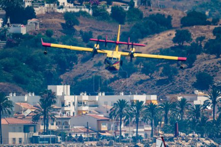 Photo for TORRE DEL MAR, MALAGA, SPAIN-JUL 28: Seaplane Canadair CL-215  taking part in a exhibition on the 2nd airshow of Torre del Mar on July 28, 2017, in Torre del Mar, Malaga, Spain - Royalty Free Image
