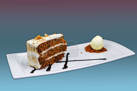 Téléchargez les photos : Composition d'un gâteau aux carottes sur une assiette blanche avec crème glacée sur fond violet et bleu clair - en image libre de droit