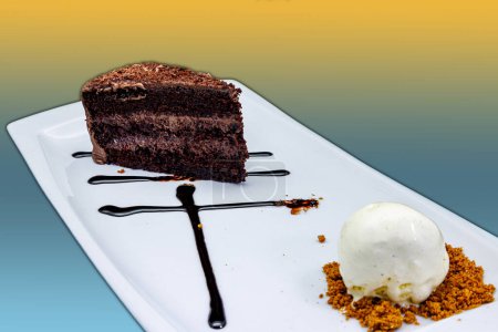 Téléchargez les photos : Composition d'un gâteau au chocolat sur une assiette blanche avec crème glacée sur fond jaune et bleu clair - en image libre de droit