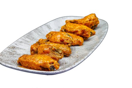 Photo for Composition of a plate of chicken wings with Buffalo sauce on a white background. - Royalty Free Image