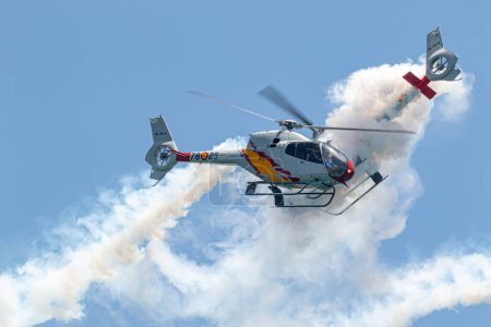 Photo for TORRE DEL MAR, MALAGA, SPAIN-JUL 14: Patrulla Aspa, Helicopter Eurocopter EC-120 Colibri taking part in a exhibition on the 4th airshow of Torre del Mar on July 14, 2019, in Torre del Mar, Malaga, Spain - Royalty Free Image
