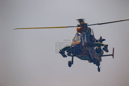 Photo for TORRE DEL MAR, MALAGA, SPAIN-JUL 28: Helicopter Eurocopter EC665 Tiger taking part in a exhibition on the 2nd airshow of Torre del Mar on July 28, 2017, in Torre del Mar, Malaga, Spain - Royalty Free Image