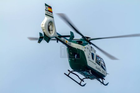 Photo for MOTRIL, GRANADA,  SPAIN-JUN 26: Helicopter Eurocopter EC-135 of the Guardia Civil taking part in an exhibition on the 11th airshow of Motril on June 26, 2016, in Motril, Granada, Spain - Royalty Free Image