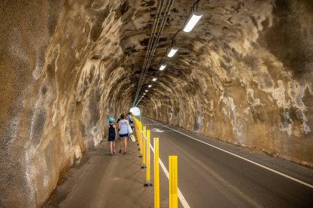 Photo for Honolulu, Hawaii - December 27, 2022: Tourists walking through the tunnel to the Diamond Head hike starting point. - Royalty Free Image