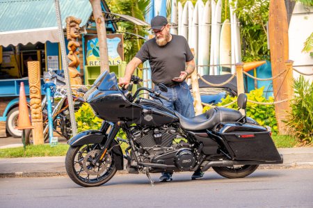 Photo for Honolulu, Hawaii - January 1, 2023: Tourist renting a Harley Davison motorcycle in Waikiki. - Royalty Free Image